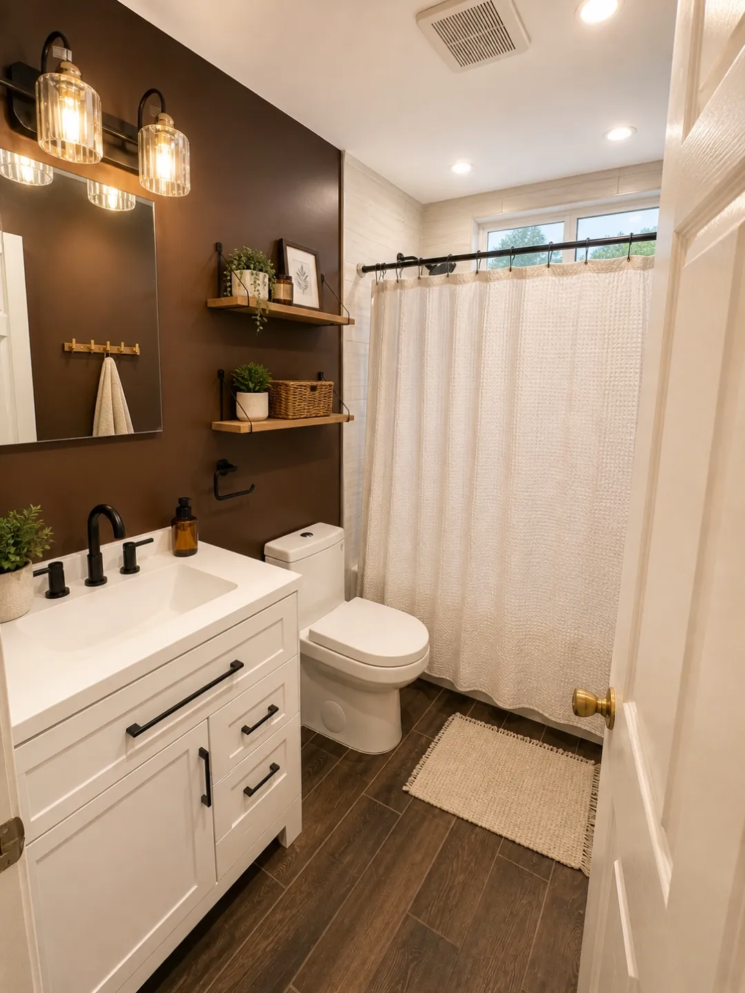 Bathroom remodel with white vanity and dark brown accent wall